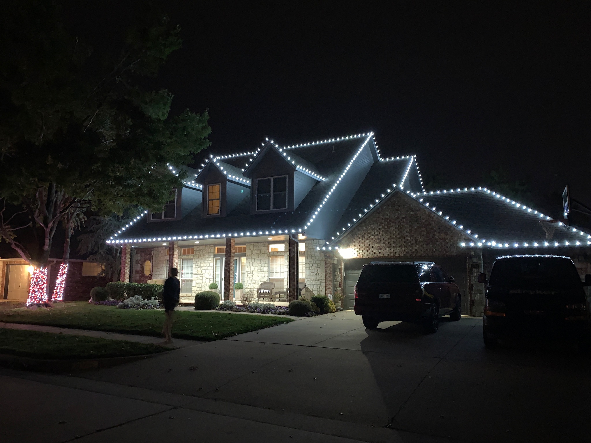 Bright white Christmas lights professionally installed on roofline demonstrating our quality work in Edmond, Oklahoma