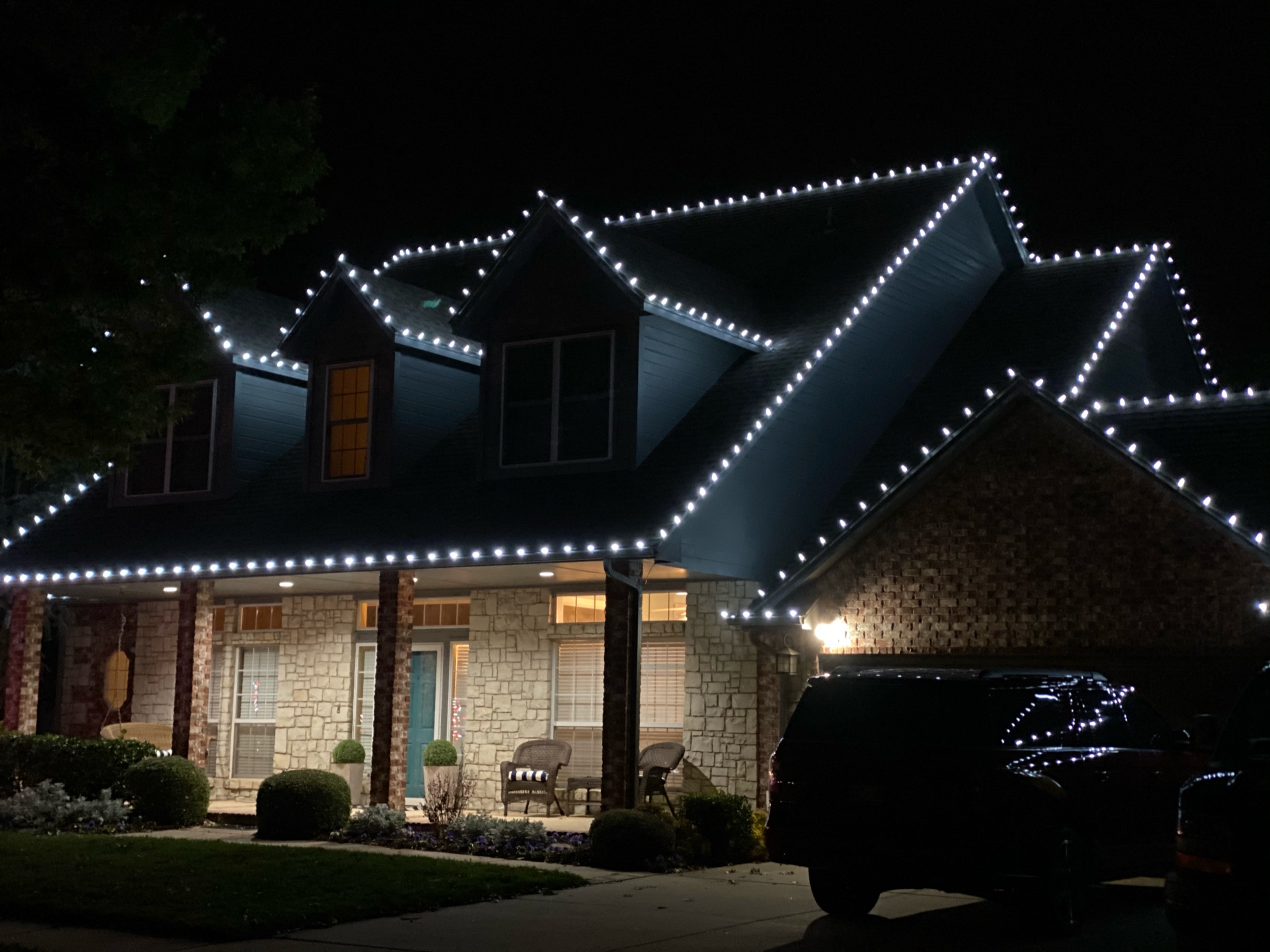Christmas light installation on a Norman OK roofline with bright white LEDs