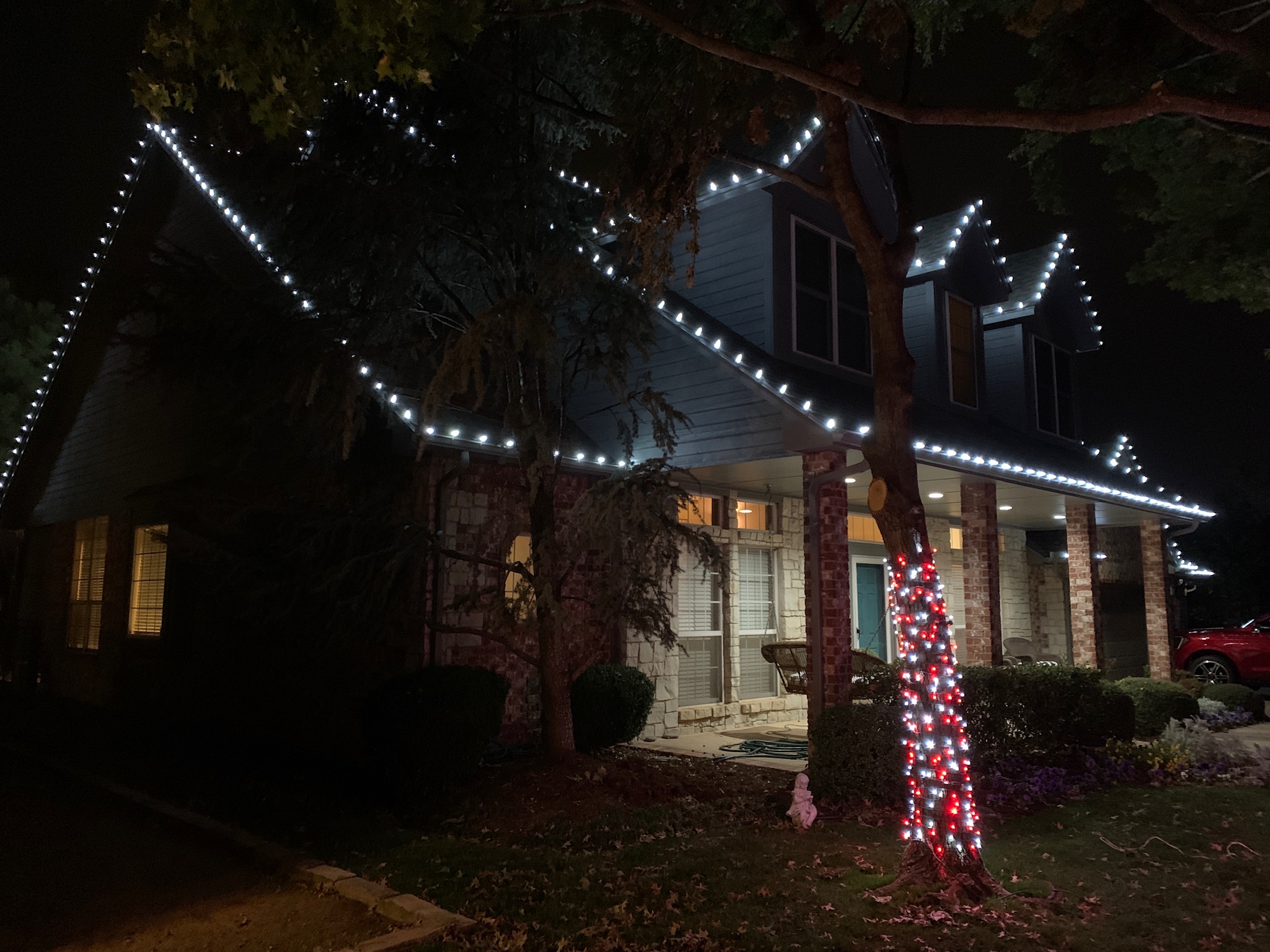 Tree wrap and roofline Christmas lights installation showing our comprehensive lighting services in Edmond