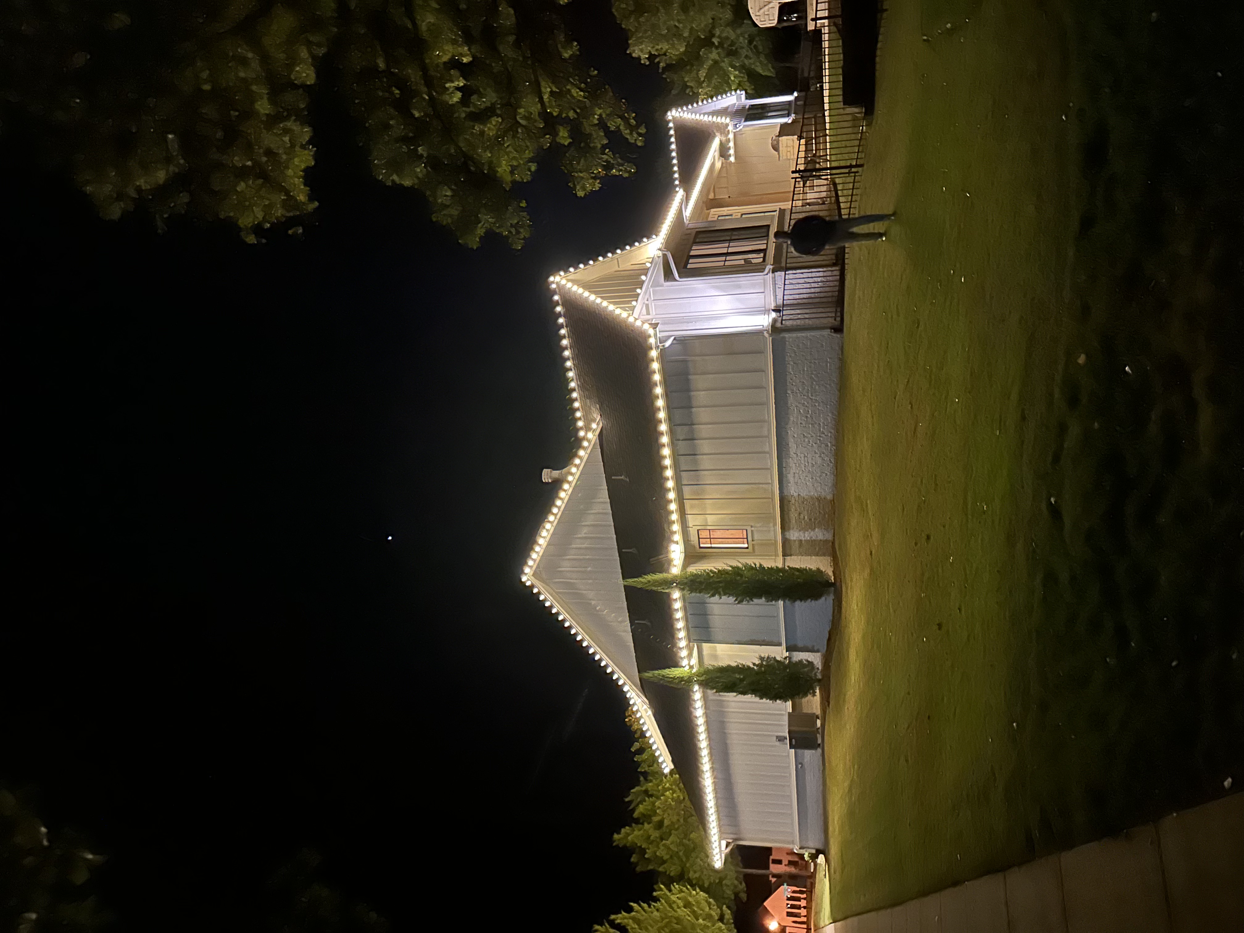 Warm white Christmas lights elegantly installed on roof showcasing our premium lighting work in The Village, Oklahoma